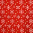Karácsonyi pamutvászon fehér hópelyhek, arany csillagok piros alapon